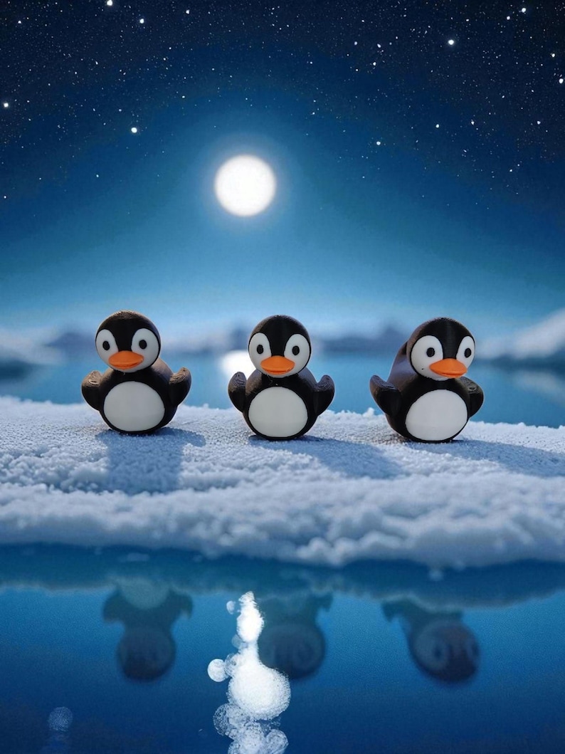 May include: Three penguin figurines with black bodies, white bellies, and orange beaks stand on a snowy surface. The background features a full moon, a starry sky, and a reflective blue body of water.