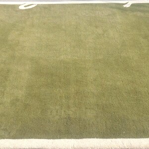 Contemporary hand tufted wool rug, plain green design with elegant ivory corner details.                                       https://theartisticcompanyin.etsy.com