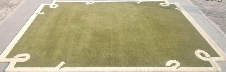 Contemporary hand tufted wool rug, plain green design with elegant ivory corner details.                                       https://theartisticcompanyin.etsy.com