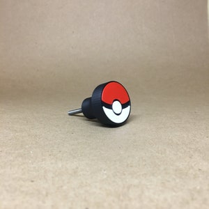 May include: A black and red 3D printed knob with a white and red Pokeball design.