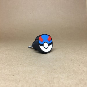 May include: Black and blue cabinet knob with a white and red Pokeball design.