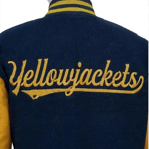 May include: A navy blue and gold varsity jacket with the text "Yellowjackets" embroidered on the back in gold.