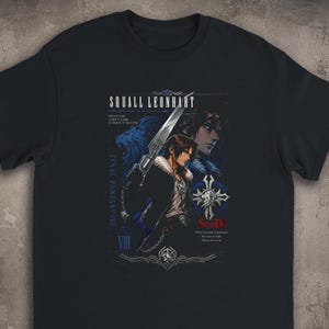 May include: A black short-sleeved t-shirt featuring a graphic print of Squall Leonhart from Final Fantasy VIII. The design includes the character holding a gunblade, a blue lion silhouette, the text "SeeD," and "Final Fantasy VIII" in white.