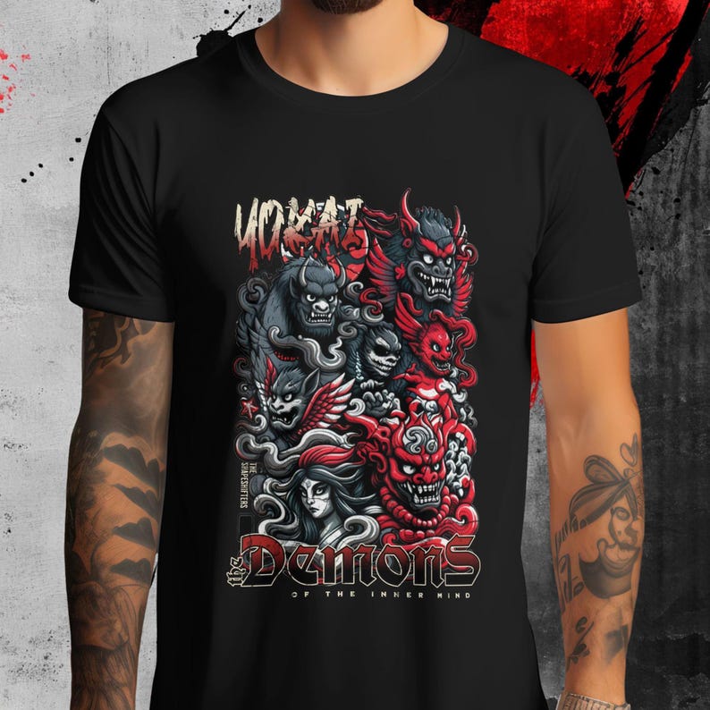 May include: Black t-shirt featuring a detailed graphic of stylized demons in red, gray, and white. The design includes the text "Demons of the Inner Mind" and "The Supplicants". The word "YOKAI" is also visible at the top of the design.
