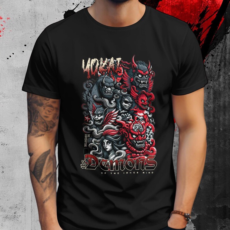 May include: Black t-shirt featuring a colorful graphic of various demons with the text "YOKAI" at the top and "The Demons of the Inner Mind" at the bottom. The design includes red, gray, and white elements.
