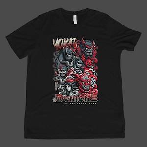 May include: Black t-shirt featuring a graphic of several demons in red, gray, and black. The text "YOKAI" is at the top, with "DEMONS OF THE INNER WIND" at the bottom. The design is centered on the shirt.