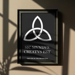 May include: Framed black and white art print featuring a white triquetra symbol on a black background. The text "SIC MVNDVS CREATVS EST" and "THE END IS THE BEGINNING" are below the symbol. The frame is black.