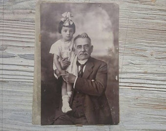 Vintage family photo, grandpa and granddaughter portrait, studio photo