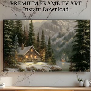 May include: A framed landscape painting of a cabin in a snowy forest, with the text "PREMIUM FRAME TV ART Instant Download". The cabin is lit from within, surrounded by evergreen trees and a mountain range in the background.