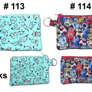May include: Small zippered coin purses with key rings. One purse is light blue with a cartoon character print. The other purse has a red zipper and features a print of various robot characters. The purses are labeled #113 and #114.