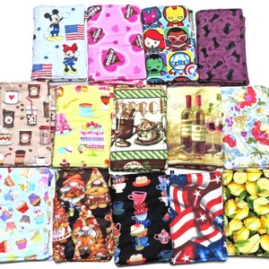 May include: Set of 12 colorful fabric pot holders with various designs, including cartoon characters, food and drink themes, and abstract patterns.