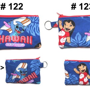 May include: Blue coin purses with red zippers and key rings. One purse features Stitch surfing with the text "Hawaii Surf Club". The other purse shows Lilo waving. Both purses have a blue floral background.