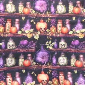 May include: A fabric pattern featuring a dark background with repeating shelves holding various glass bottles, jars, and orange pumpkins. Some jars contain skulls, while others hold plants. The design includes purple and orange accents throughout.