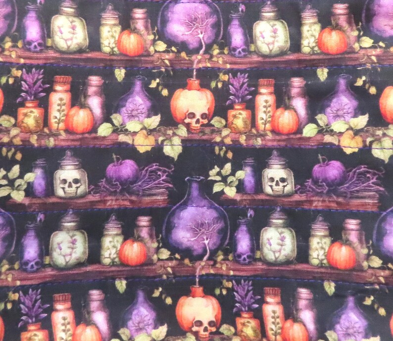 May include: A fabric pattern featuring a dark background with repeating shelves holding various glass bottles, jars, and orange pumpkins. Some jars contain skulls, while others hold plants. The design includes purple and orange accents throughout.
