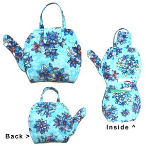 May include: A quilted, light blue handbag with a floral pattern in shades of blue, purple, and white. The bag has a handle and a spout-like extension. The image shows the front, back, and inside of the bag. The text "Back >" and "Inside ^" are visible.