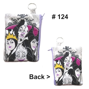 May include: A small, square coin purse with a zipper closure and a key ring. The front features a colorful graphic of Disney villains, including Cruella de Vil and Ursula. The background is a light gray with a spiderweb pattern. The text "# 124" is visible.