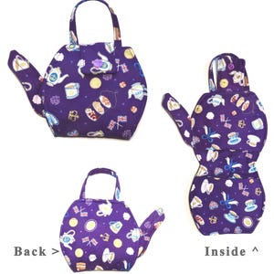 May include: A purple teapot-shaped tea cozy with a handle, spout, and a small pocket. The fabric is patterned with teacups, teapots, and British flags. The image shows the front, back, and inside of the cozy.