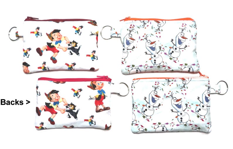 May include: Four small, rectangular zippered pouches. Two pouches feature a print of Pinocchio and Figaro the cat, with red zipper trim. The other two pouches have a print of Olaf from Frozen, with orange zipper trim. Each pouch has a silver key ring.