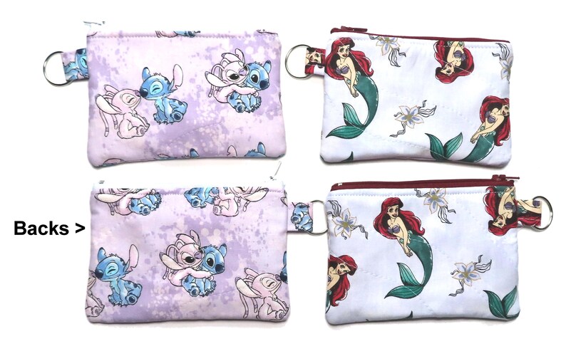 May include: Four small zippered pouches. Two pouches feature a Stitch and Angel design on a lavender background. The other two pouches have a Little Mermaid design on a white background. Each pouch has a key ring.