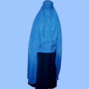 May include: A long, flowing blue veil with a decorative trim around the neckline. The veil is made of a silky fabric and is worn over the head and shoulders.