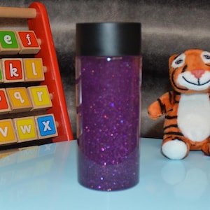 Purple Glittery Sensory Bottle for Kids Learning Development | Handmade Gift to Entertain and Calm Children&#39;s Sensory Needs.
