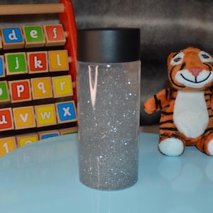 Silver Glittery Sensory Bottle for Kids Learning Development | Handmade Gift to Entertain and Calm Children&#39;s Sensory Needs.