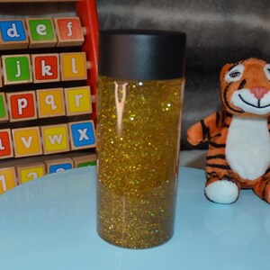 Gold Glittery Sensory Bottle for Kids Learning Development | Handmade Gift to Entertain and Calm Children&#39;s Sensory Needs.