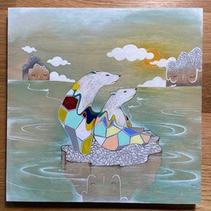 May include: Two white polar bears with geometric patterns on their backs sit on a small island in a green and blue water. The island is surrounded by water with ripples. The sky is a light blue with white clouds and a yellow sun.