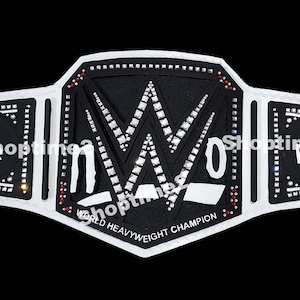 May include: A white and black wrestling championship belt with the letters "WWE" in the center. The belt has the words "World Heavyweight Champion" and "NWO" on it. The belt is decorated with rhinestones.