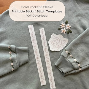 May include: Sage green sweatshirt with floral embroidery on the sleeve cuffs. Includes printable stick-and-stitch templates for floral pocket and sleeve designs. The text on the image reads: "Floral Pocket & Sleeve Printable Stick n' Stitch Templates PDF Download."