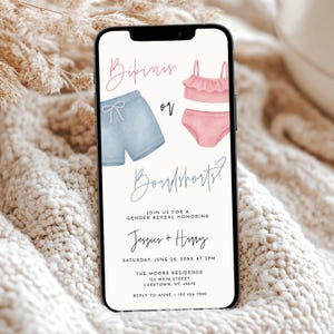 May include: A smartphone displays a gender reveal invitation. The invitation features watercolor illustrations of a blue swim trunk and a pink bikini. Text includes "Bikinis or Boardshorts?" and event details.