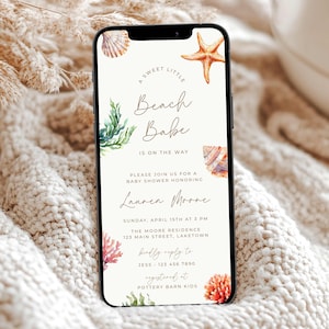 May include: A smartphone displays a baby shower invitation with a beach theme. The text reads "A Sweet Little Beach Babe Is On The Way." The design includes watercolor illustrations of seashells, starfish, and coral. The invitation is for Lauren Moore.
