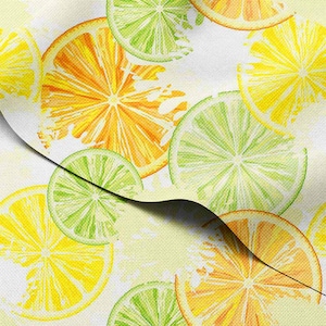 May include: A textile design featuring a pattern of citrus fruit slices. The pattern includes yellow lemons, orange oranges, and green limes on a white backdrop. The fruit slices are detailed with visible segments and textures.