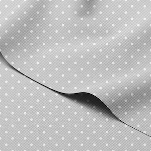 May include: A close-up of a gray fabric with a repeating pattern of small white polka dots. The fabric is folded, creating shadows and highlighting the texture. The material appears to be a woven textile.