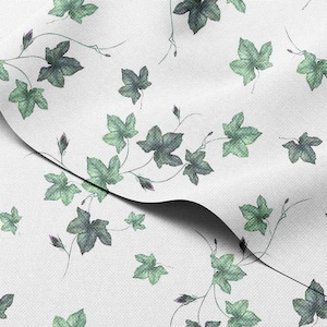 May include: White fabric featuring a repeating pattern of green ivy leaves and stems. The leaves are in varying shades of green, creating a natural, botanical design. The fabric has a subtle texture.