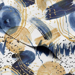 May include: Abstract art fabric with a white background, featuring navy blue brushstrokes, gold lines, and tan circles. The design includes small black speckles, creating a modern, artistic pattern. This fabric is suitable for various craft projects.
