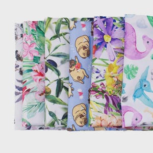 A collection of colorful fabric swatches, each with a unique pattern, including floral designs, animals, and abstract shapes.