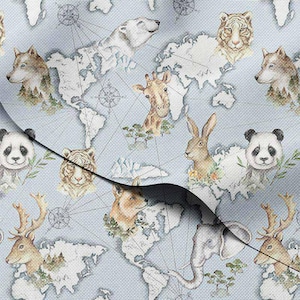 May include: Light blue fabric featuring a world map design with various animals. The animals include a polar bear, tiger, wolf, giraffe, rabbit, panda, deer, and elephant. The map is white with compass rose details.