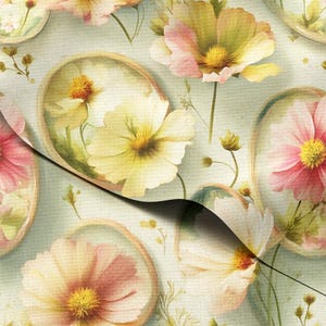 May include: A floral pattern with watercolour-style cosmos flowers in pink, yellow, and white. The flowers are set against a light green background, creating a soft, artistic design. The pattern is suitable for fabric or wallpaper.