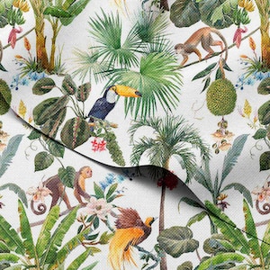 May include: A white fabric with a vibrant tropical jungle pattern. The design features toucans, monkeys, palm trees, and exotic flowers in shades of green, yellow, blue, and brown. The overall theme is a lush, colorful rainforest.
