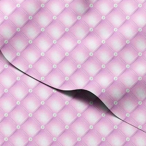 May include: Close-up of a pink quilted fabric with a diamond pattern. Each diamond is accented with a small, white, circular detail. The fabric is folded over, revealing the texture and pattern.
