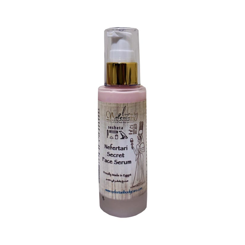May include: A pink bottle of Nefertari Secret Face Serum with a gold cap and a white pump. The bottle has a label with an image of an Egyptian woman and hieroglyphics. The text on the label reads "sesheta Nefertari Secret Face Serum Proudly Made in Egypt www.nefertaribodyspa.com".