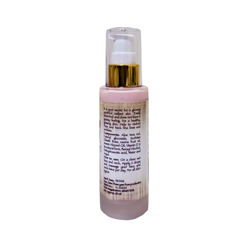 May include: A pink bottle of face cream with a gold cap and a white pump. The bottle is labeled with the text "your secret for a glowing youthful nature skin. Easily absorbed and does not leave a greasy feeling. Try for a healthier glowing red skin. Helps to reduce wrinkles. Help to heal and face and Neck fine lines and wrinkles."