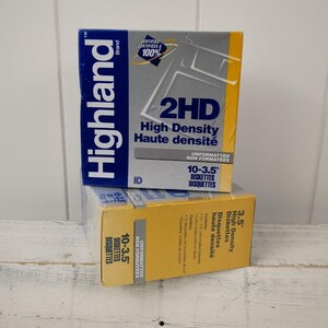 May include: Two boxes of Highland Brand 3.5" high-density diskettes. The boxes are yellow and gray with blue accents. The text "2HD High Density Haute densité" is visible on the front of the top box. The boxes are stacked on top of each other.