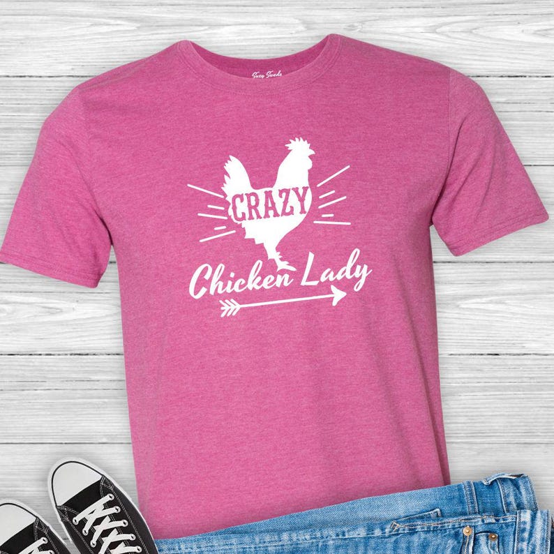 May include: Pink t-shirt with a white silhouette of a chicken and the text "Crazy Chicken Lady" with an arrow pointing to the right.