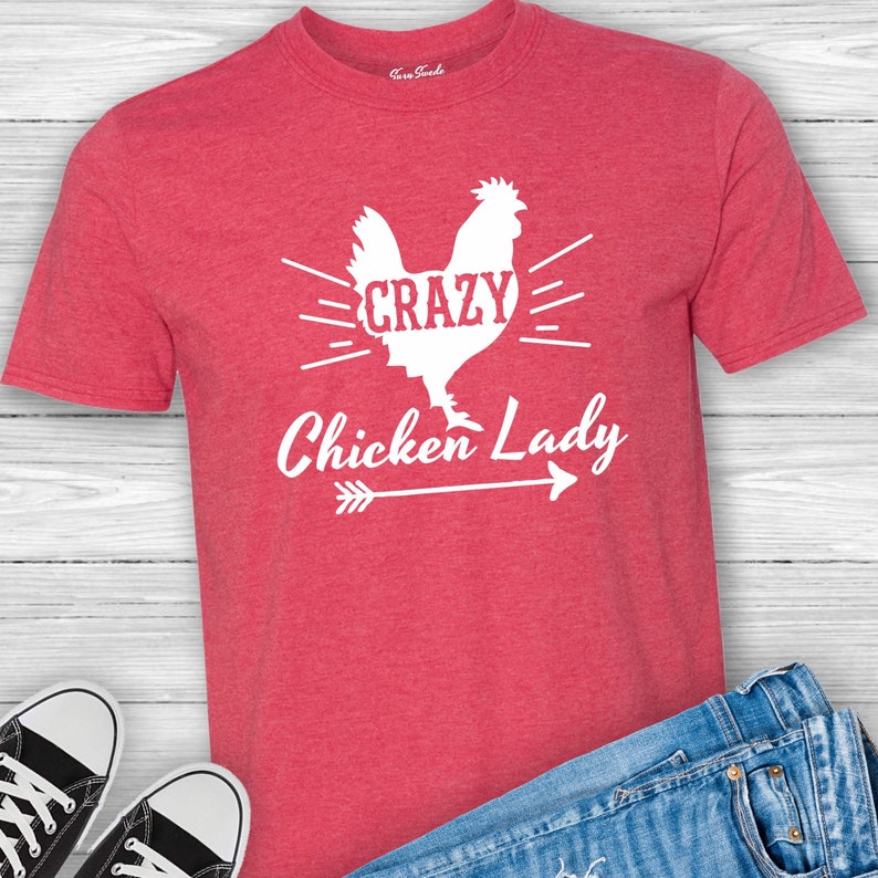 May include: Red t-shirt with a white silhouette of a chicken and the text "Crazy Chicken Lady" with an arrow pointing to the right.