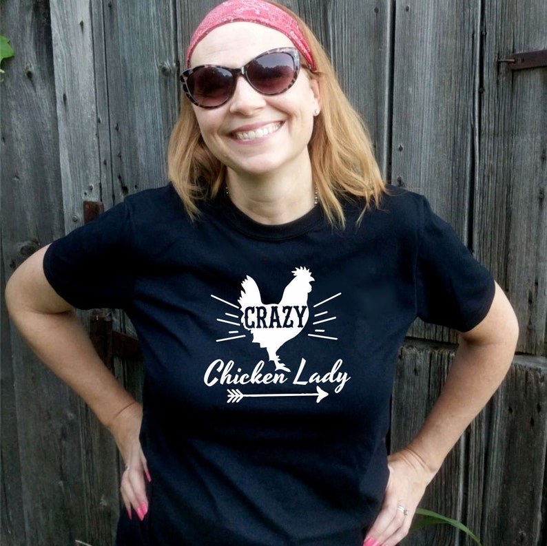 May include: A black t-shirt with a white graphic of a chicken and the text "Crazy Chicken Lady" with an arrow pointing to the right.