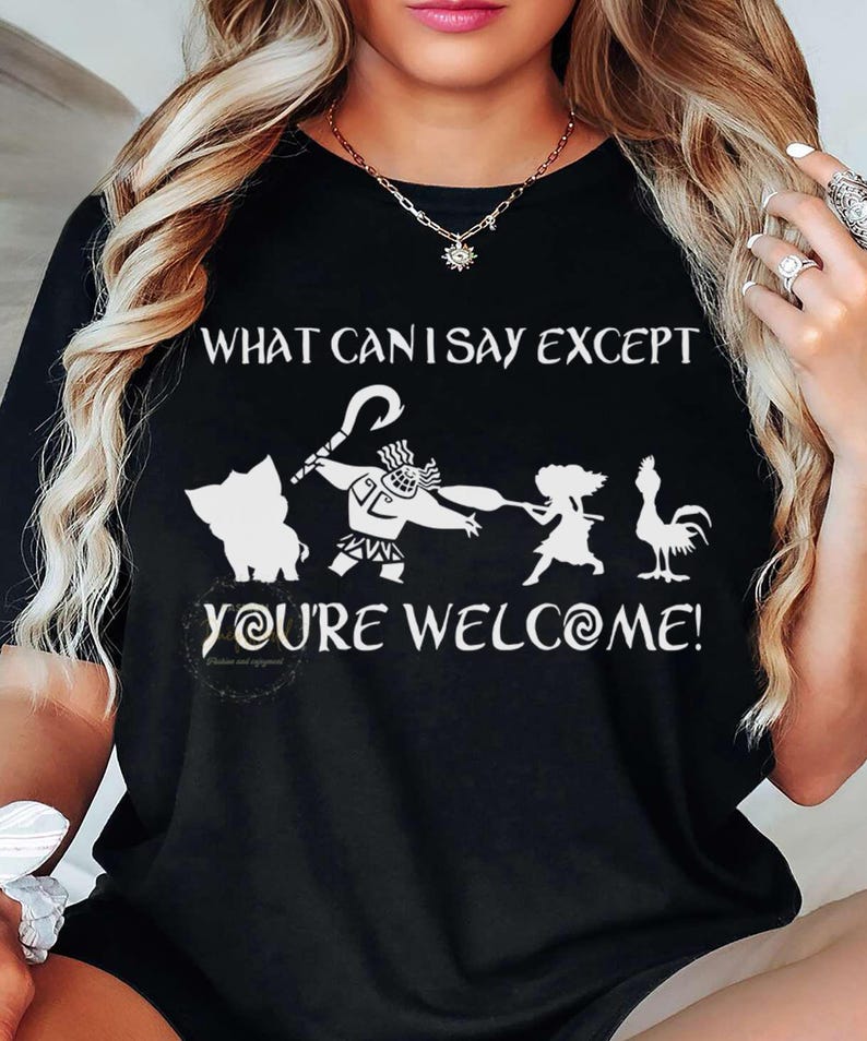 Puede incluir: Camiseta negra con un gr&aacute;fico blanco de personajes y el texto "WHAT CAN I SAY EXCEPT YOU'RE WELCOME!". El dise&ntilde;o incluye un cerdo, un personaje con un gancho, una ni&ntilde;a y un gallo. La camiseta es de cuello redondo.