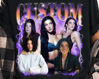 May include: Black t-shirt with a graphic design featuring the word "CUSTOM" in an orange and purple gradient font. The design includes images of several women. The shirt is worn by a person wearing a black and white checked shirt.