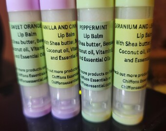 May include: Four lip balm tubes with different scents: Sweet Orange, Vanilla and Cinnamon, Peppermint, and Geranium and Lemon. Each tube has a white label with black text listing the scent and ingredients, including shea butter, coconut oil, vitamin E, and essential oils.